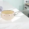A cream-colored saucepan with red heart decorations sits on a white countertop. Produktbild-Vorschau