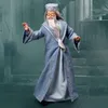 A doll of Albus Dumbledore in a blue robe, standing in front of a stone staircase. Podgląd zdjęcia produktu