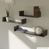 Three dark gray U-shaped shelves mounted on a light gray wall, with a plant on the top left shelf, books on the middle and bottom shelves, and a clock on the bottom shelf. Voir les images du produit