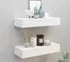 Two white floating shelves mounted on a light gray wall, decorated with various home decor items. Produktbild-Vorschau
