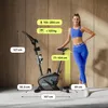 A woman stands next to a stationary exercise bike, with various dimensions and weight limits indicated by text overlays. Produktbild-Vorschau