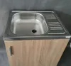 A stainless steel sink with a draining board is installed on a wooden cabinet. Podgląd zdjęcia produktu