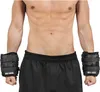 A person wearing black weight cuffs on their wrists. Náhľad obrázku produktu