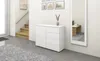 A white dresser is shown in a hallway next to a staircase and a mirror. Produktbild-Vorschau