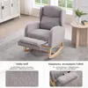 A grey rocking chair with a footrest is shown in a room with a white cabinet and a window in the background. Text boxes below describe the fabric and the footrest. Podgląd zdjęcia produktu