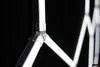 A close-up view of the connection point of a white LED light fixture, against a dark background. Podgląd zdjęcia produktu