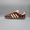 A single Adidas Samba OG shoe with a leopard print pattern is shown against a plain gray background. Podgląd zdjęcia produktu