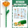An image showing a constructed flower made of building blocks, along with its instruction manual and loose building blocks. Produktbild-Vorschau