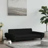 A black dog bed is shown in a living room setting with a plant and a painting on the wall. Produktbild-Vorschau