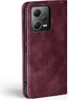 A close-up side view of a burgundy flip-style phone case for a Xiaomi Redmi Note 12 Pro 5G, showing the camera module. Produktbild-Vorschau