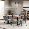 A dining room scene with a wooden table and chairs, set for a meal. Produktbild-Vorschau