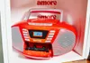 An orange Blaupunkt boombox with a cassette deck is displayed in a white shelf. Produktbild-Vorschau