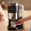 A hand is shown placing a coffee mug under a Philips coffee maker. Produktbild-Vorschau