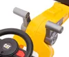 A close-up view of the steering wheel and control levers of a yellow toy construction vehicle. Náhled obrázku produktu