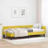 A yellow bed frame with bedding in a room. Podgląd zdjęcia produktu