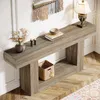 A console table with decorative items and a basket on a wooden floor. Anteprima dell’immagine prodotto