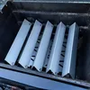 Several metal heat deflectors are arranged inside a grill. Produktbild-Vorschau