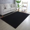 A living room scene with a sofa, a rug, and a plant. Produktbild-Vorschau