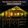A wooden house decorated with icicle-shaped LED lights at night. Produktbild-Vorschau