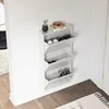A white shoe cabinet with three flip-down compartments is mounted on a white wall. The cabinet contains several pairs of shoes. On top of the cabinet, there is a small potted plant and a decorative bowl. Anteprima dell’immagine prodotto