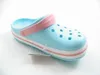 A single light blue Crocs Crocband Clog with pink accents is shown against a white background. Produktbild-Vorschau