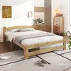 A bedroom scene with a wooden bed frame and bedding. Produktbild-Vorschau