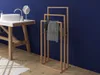 A bathroom scene with a sink and a towel rack. Voir les images du produit