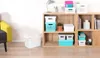Storage boxes on a shelf and on the floor next to a chair. Náhľad obrázku produktu