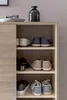 A shoe cabinet with several shelves filled with shoes. Produktbild-Vorschau