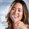 A woman is brushing her teeth with an electric toothbrush, with a diagram showing a pressure sensor. Produktbild-Vorschau