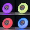 A collage of four images showing a digital alarm clock with a sunrise simulation feature, displaying different colored lights. Produktbild-Vorschau