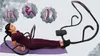 A woman is using an ab workout machine, with graphic icons illustrating abdominal muscles, a sit-up, and a spine. Produktbild-Vorschau