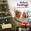 A grandmother and granddaughter are hugging in front of a decorated Christmas tree, with a gift in the granddaughter's lap. Produktbild-Vorschau