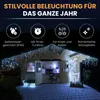 A wooden cabin decorated with icicle lights and a reindeer. Produktbild-Vorschau