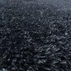 Close-up view of a dark gray shaggy rug. Produktbild-Vorschau