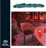 An outdoor seating area with a chair and drinks, suggesting a relaxed atmosphere. Produktbild-Vorschau