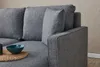A close-up view of a grey sofa with cushions and an armrest. Produktbild-Vorschau