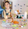 A young girl is shown at a table with a horse craft kit. Produktbild-Vorschau