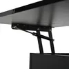 A close-up view of the underside of a black table, showing a gas spring mechanism used for height adjustment. Produktbild-Vorschau