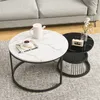 Two round coffee tables with marble patterns are placed on a rug in front of a sofa. Produktbild-Vorschau