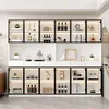 A modern white display cabinet with black aluminum frames and glass doors, filled with various decorative items and bottles. Podgląd zdjęcia produktu
