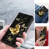 A collage of images showing a black phone case with gold butterfly designs, being held, in a pocket, and by a person. Produktbild-Vorschau