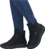A person wearing blue jeans and black boots. Podgląd zdjęcia produktu