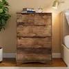 A dresser with books and an alarm clock on top, next to a bed. Podgląd zdjęcia produktu