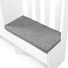 A close-up view of a white hallway cabinet with a gray cushion on top. Produktbild-Vorschau