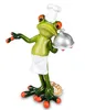 Eine niedliche Froschfigur, die als Koch verkleidet ist. Er trägt eine weiße Kochmütze und Schürze  Produktbild-Vorschau