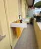 A balcony with a wall-mounted drying rack with clothes hanging on it. Produktbild-Vorschau