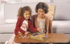 A mother and daughter are playing a board game together at a table. Voir les images du produit