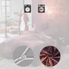 A woman in a robe stands in a bedroom with a bed covered in patterned bedding. Icons for washing and temperature are visible. Produktbild-Vorschau