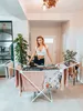 A woman is standing behind a clothes drying rack in a well-lit room. Náhled obrázku produktu